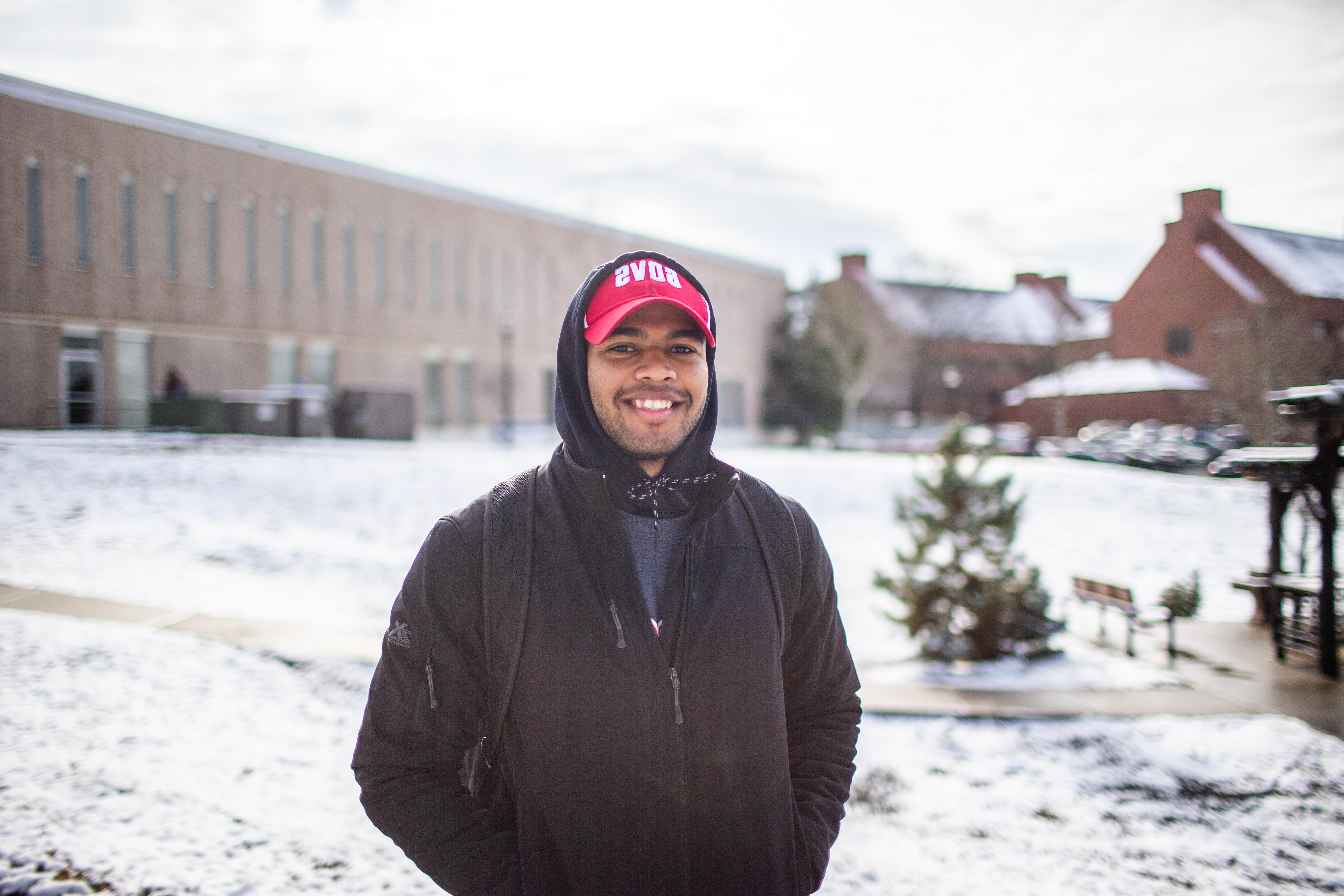 student happily on campus during winter